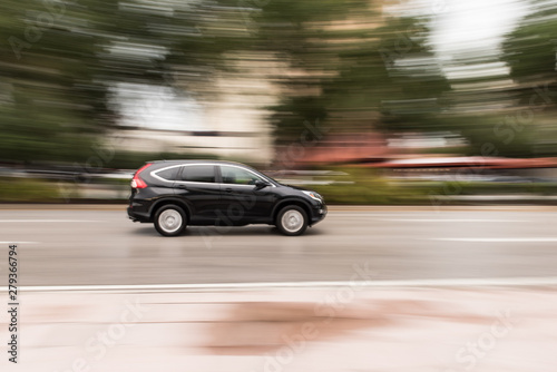 Motion Blur of Car Speeding Down a City Street