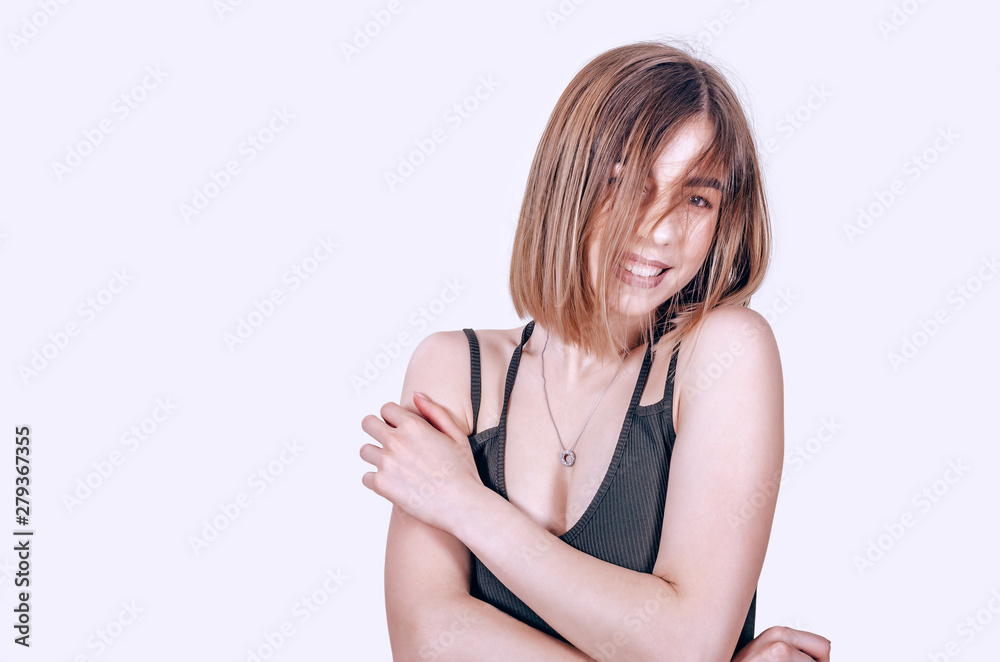 Portrait of a pretty girl looking at the camera, smiling at her face, wearing a bodysuit, hair covered face Portrait of a pretty girl looking at the camera, smiling at her face, wearing a bodysuit, hair covered face