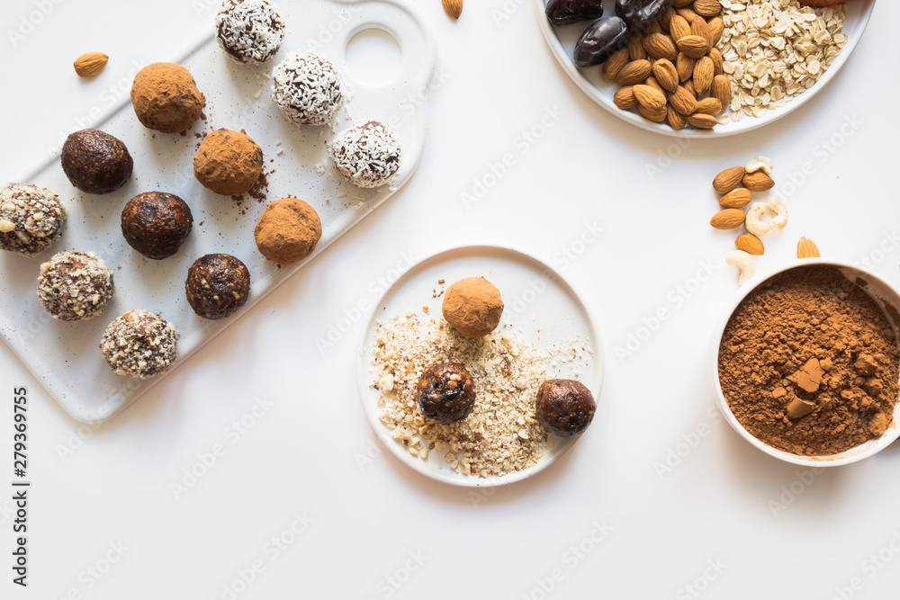 Energy balls with cacao and nuts on white. Healthy food for children and vegan. Energy balls with cacao and nuts on white. Healthy food for children and vegan.