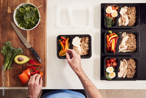 Fotografie Overhead Shot Of Man Preparing Batch Of Healthy Meals At Home In Kitchen