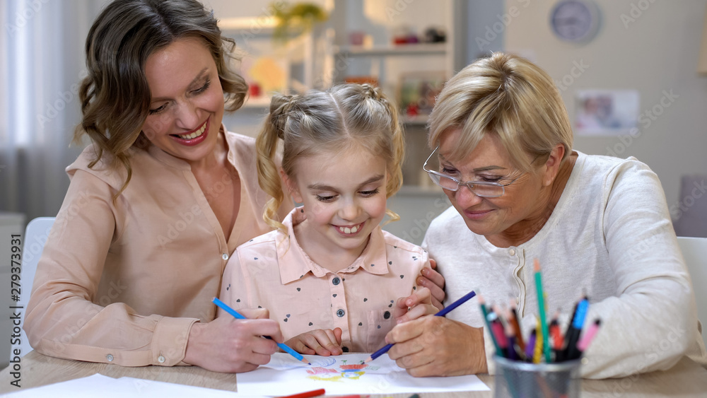Elderly mother, daughter and grandchild drawing by color pencils, time together Elderly mother, daughter and grandchild drawing by color pencils, time together