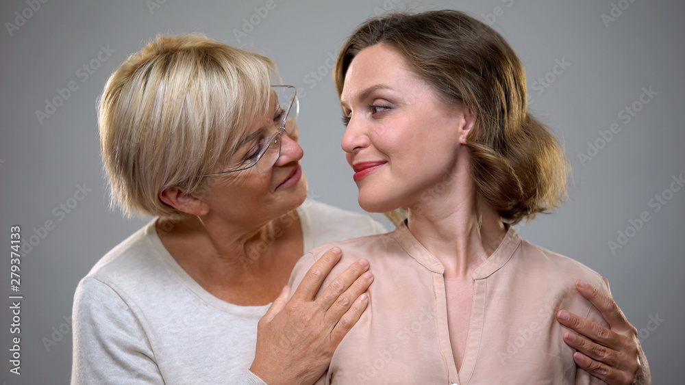Loving senior mother and daughter looking at each other, tender female relations Loving senior mother and daughter looking at each other, tender female relations