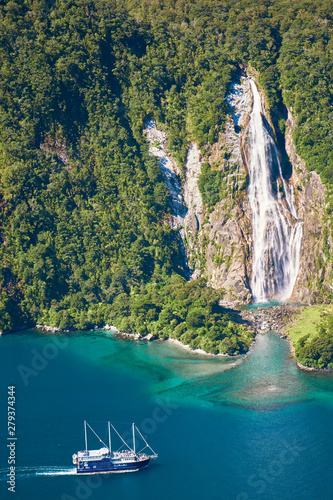 Boat approaching waterfall 