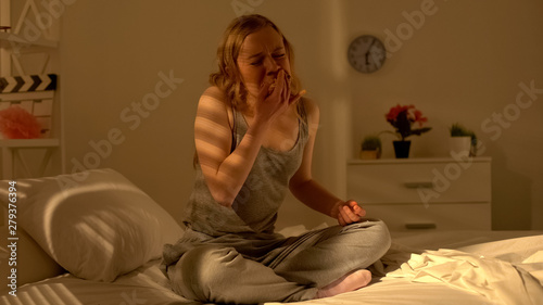 Depressed teenage girl eating on bed young age bulimia suffering mental disorder photo