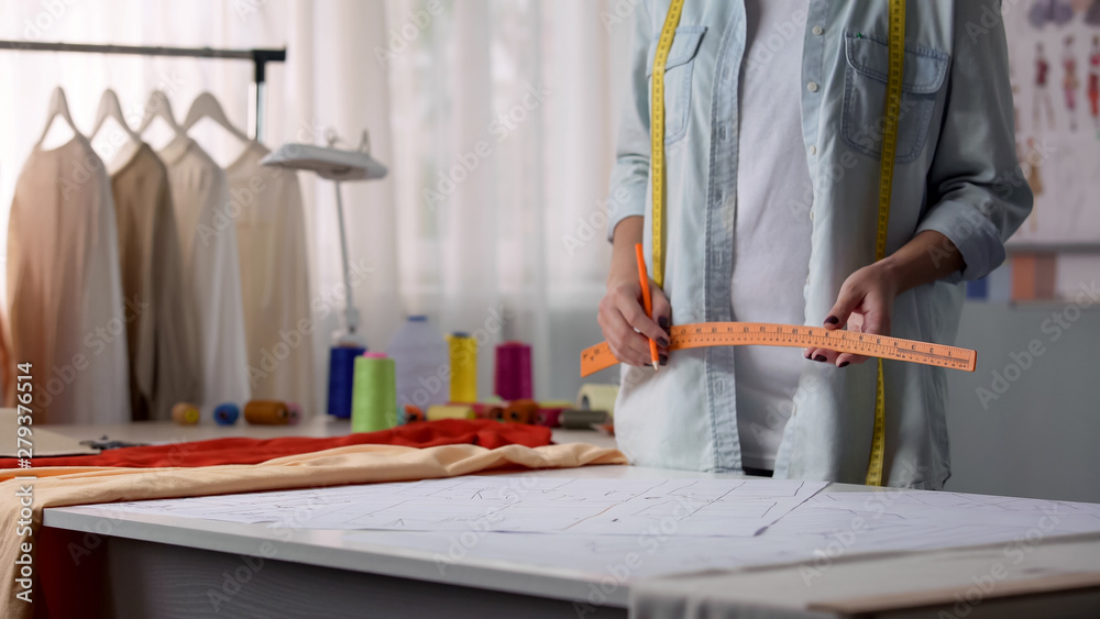 Fashion designer going to draw pattern according to client size, clothes making Fashion designer going to draw pattern according to client size, clothes making