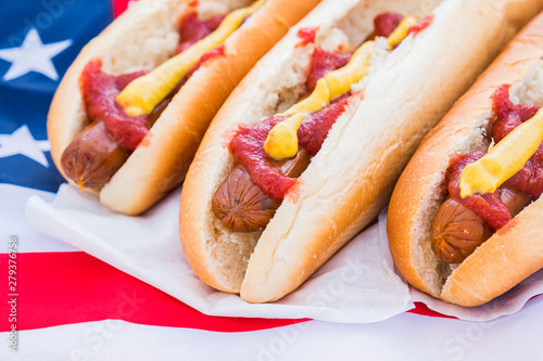 Hot dogs with ketchup and mustard, close-up view. American fast food concept: hotdogs served and ready to eat