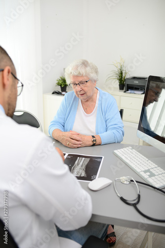 elderly senior woman having a medical consultation with her doctor in office diagnostic