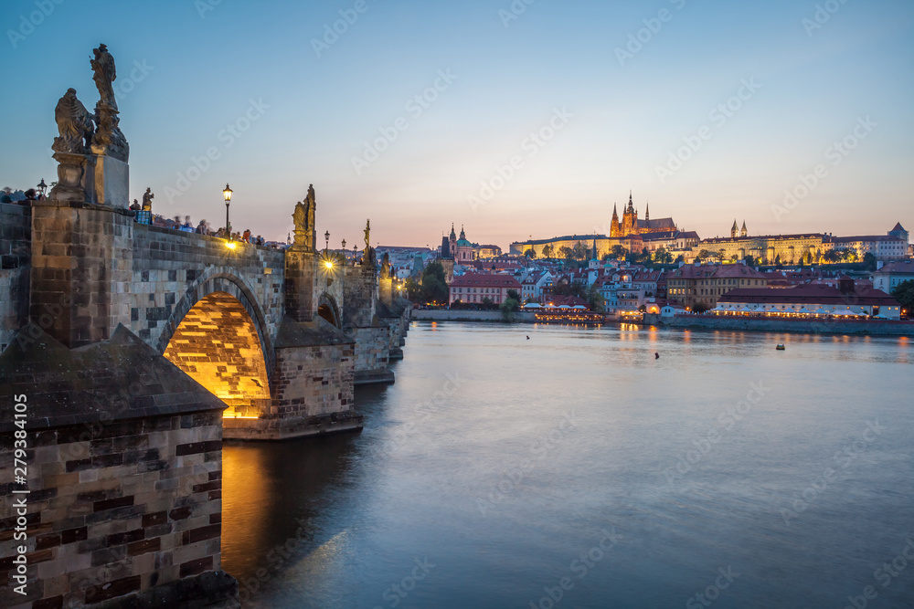 Prague Castle and Charles Bridge in the evening, Prague, Czech Republic, Vltava river in foreground.