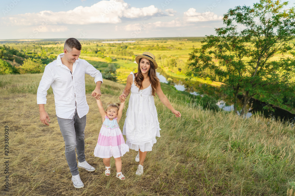 Parents are having fun with their little daughter. Family values Parents are having fun with their little daughter. Family values