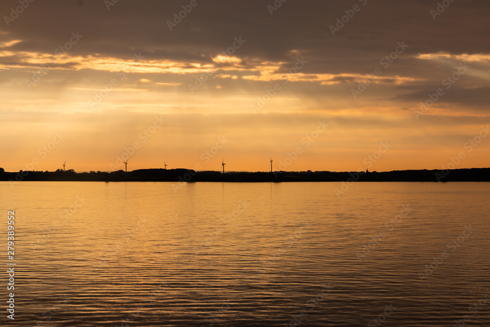 Beautiful sunset at the sea called Kattegat, with windmills in the background
