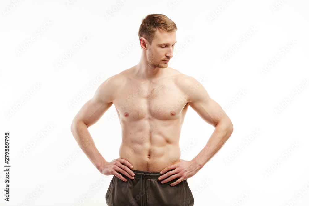Muscular man poses at the camera topless.