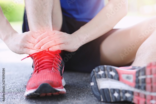  Men injury, ankle pain after jogging, health care concept