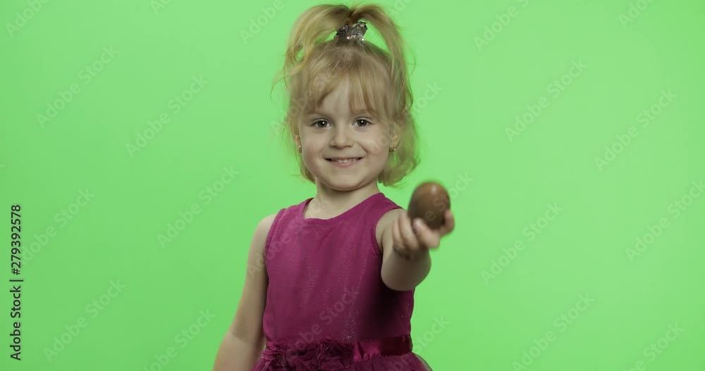 Girl in purple dress with chocolate egg. Happy four years old child. Chroma Key Girl in purple dress with chocolate egg. Happy four years old child. Chroma Key