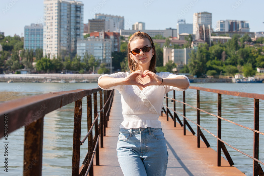 Young woman on the pier at the river.