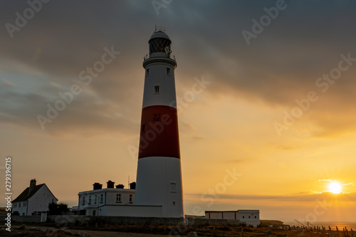 Portland Bill Lighthouse in Isle of Portland during sunrise with nicely moved clouds by a long exposed composition