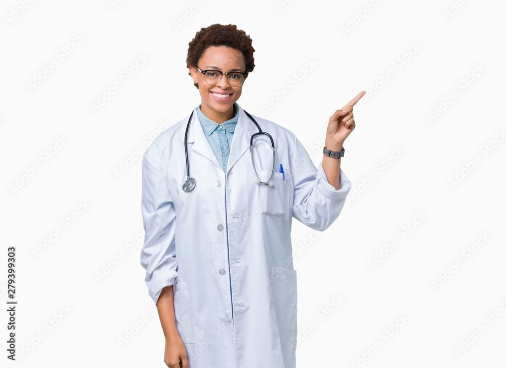 Young african american doctor woman wearing medical coat over isolated background with a big smile on face, pointing with hand and finger to the side looking at the camera. Young african american doctor woman wearing medical coat over isolated background with a big smile on face, pointing with hand and finger to the side looking at the camera.