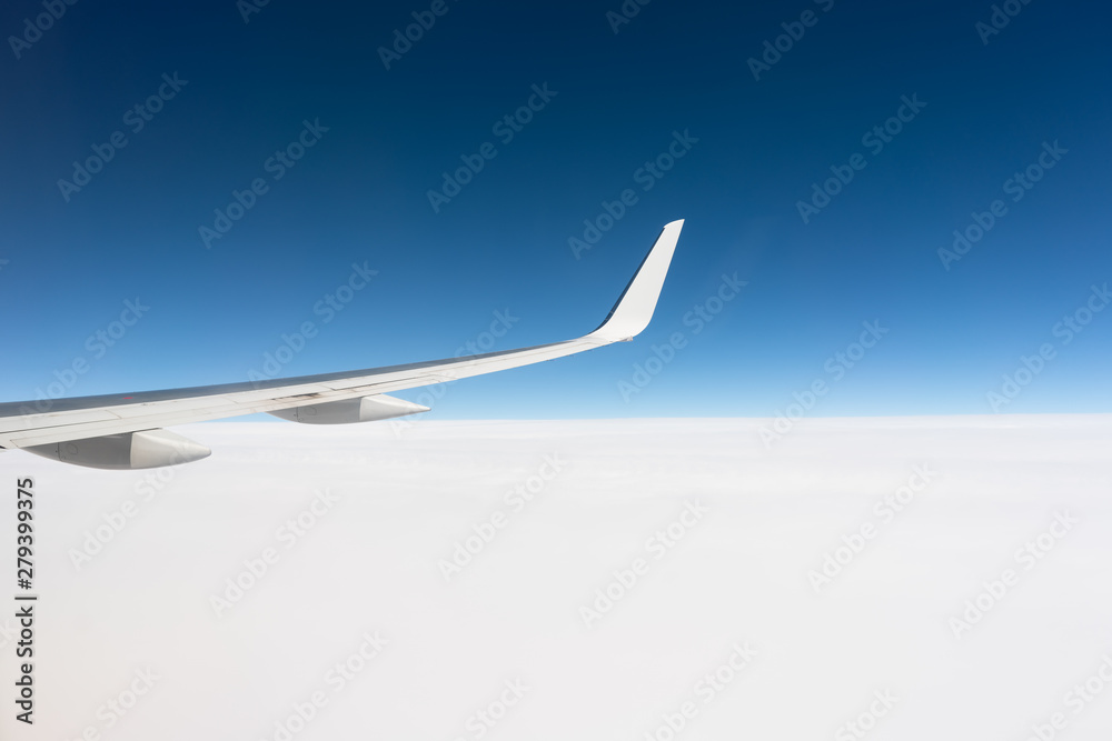 Airplane wing above the cloud line Airplane wing above the cloud line