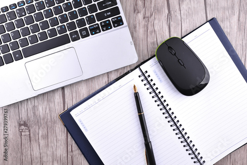 The keyboard a mouse and office accessories on a table