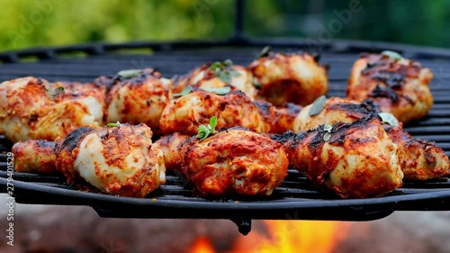 Spicy grilled chicken leg with spices on grill