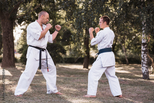 Two karate men sparring on nature