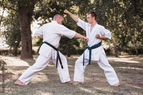 Two karate men sparring on nature