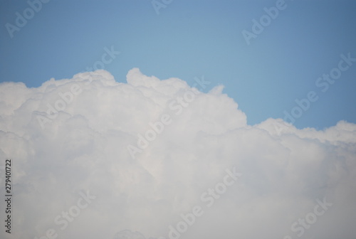 Light Blue Sky and Puffy White Cloud