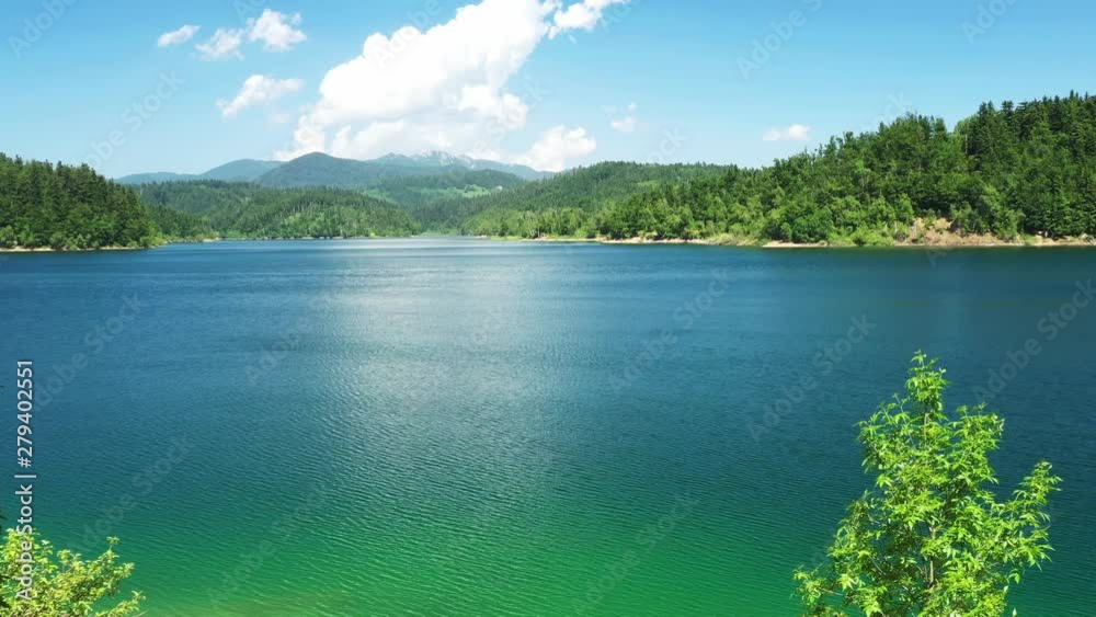 Panoramic view of beautiful Lokvarsko lake, blue lake in nature landscape in Gorski kotar, Croatia, slow drone panning shot
