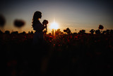cheerful girl with curly blond hair in a huge poppy field alone,