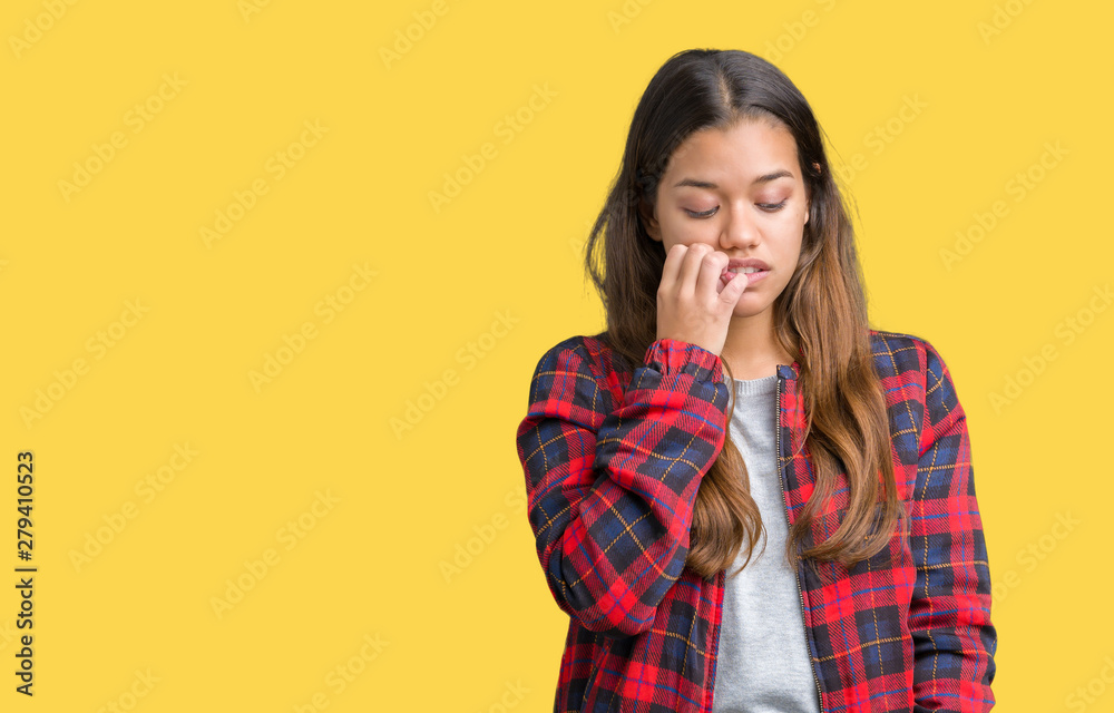 Young beautiful brunette woman wearing a jacket over isolated background looking stressed and nervous with hands on mouth biting nails. Anxiety problem. Young beautiful brunette woman wearing a jacket over isolated background looking stressed and nervous with hands on mouth biting nails. Anxiety problem.
