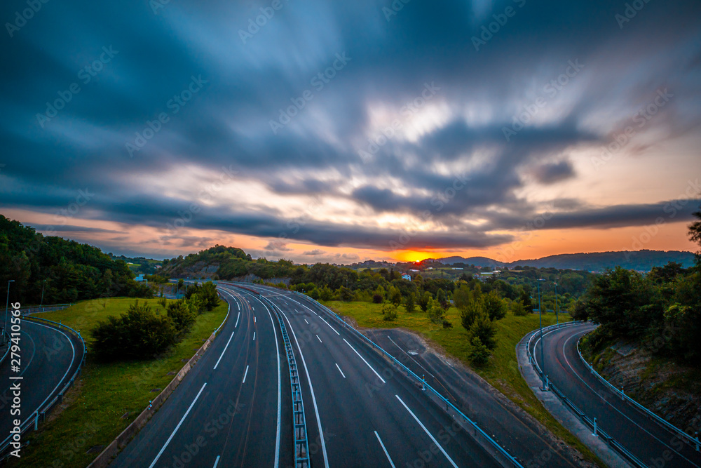 The sun ends up hiding in a long exposure photo on a road