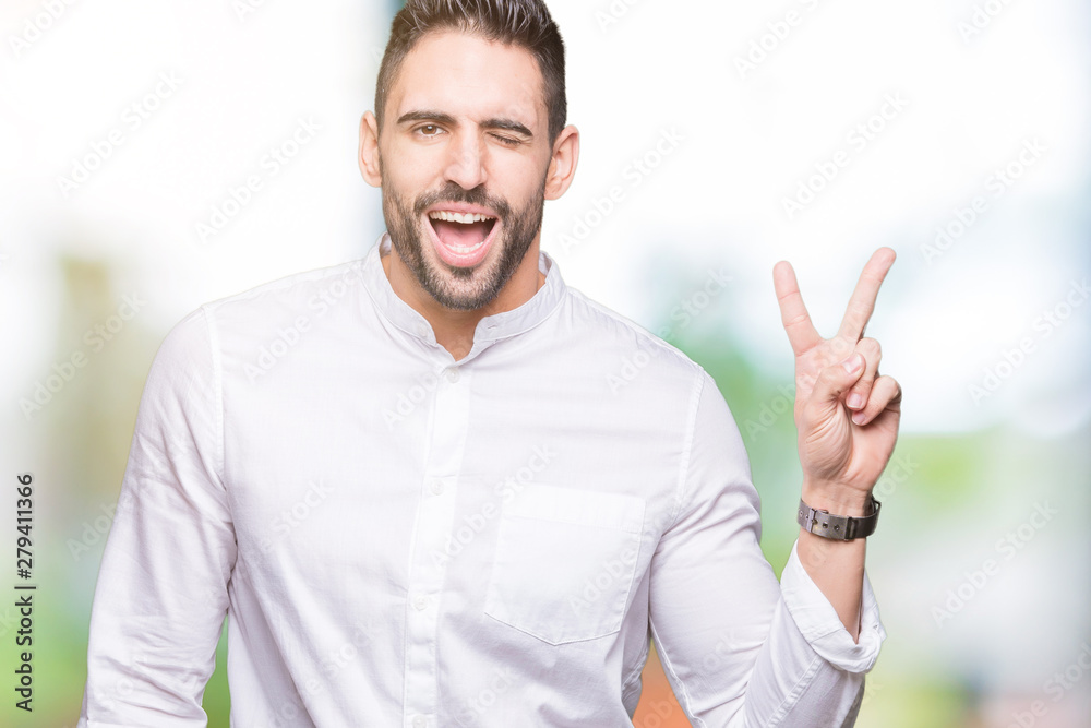 Young business man over isolated background smiling with happy face winking at the camera doing victory sign. Number two. Young business man over isolated background smiling with happy face winking at the camera doing victory sign. Number two.