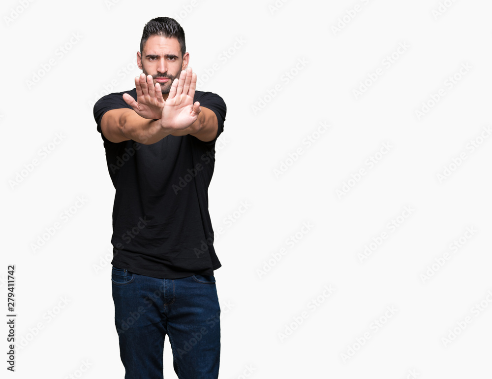 Young handsome man over isolated background Rejection expression crossing arms and palms doing negative sign, angry face Young handsome man over isolated background Rejection expression crossing arms and palms doing negative sign, angry face