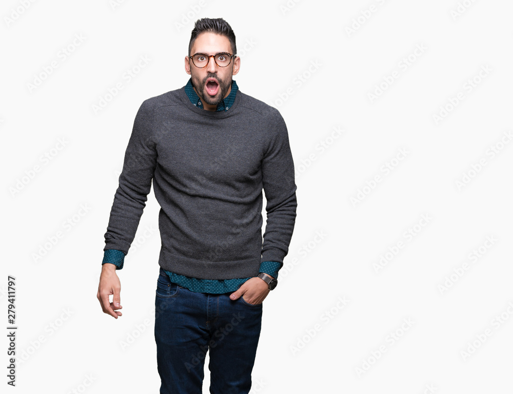 Young handsome man wearing glasses over isolated background In shock face, looking skeptical and sarcastic, surprised with open mouth Young handsome man wearing glasses over isolated background In shock face, looking skeptical and sarcastic, surprised with open mouth