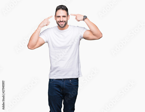 Handsome man wearing white t-shirt over white isolated background Smiling pointing to head with both hands finger, great idea or thought, good memory