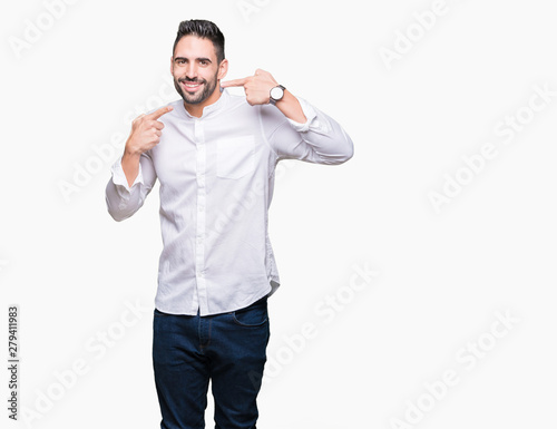 Young business man over isolated background smiling confident showing and pointing with fingers teeth and mouth. Health concept.