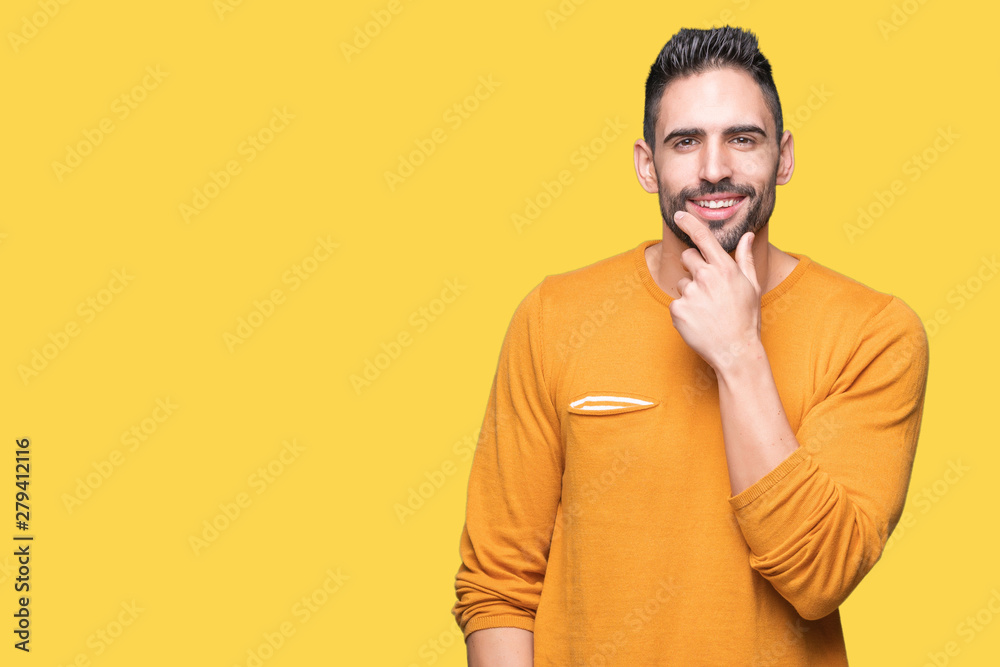 Young handsome man over isolated background looking confident at the camera with smile with crossed arms and hand raised on chin. Thinking positive.