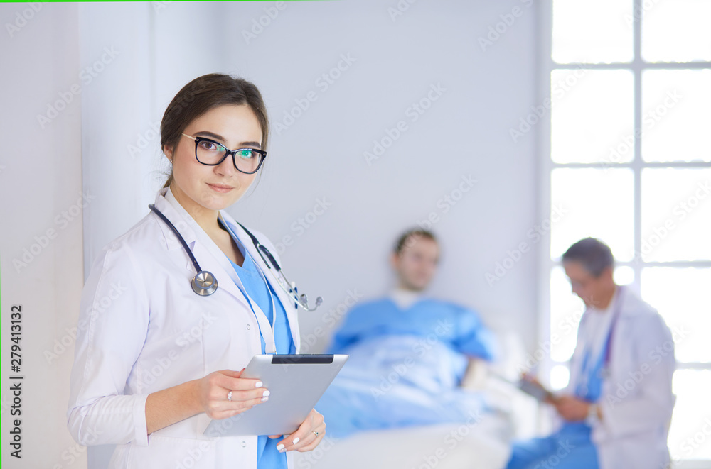 Female doctor using tablet computer in hospital lobby Female doctor using tablet computer in hospital lobby