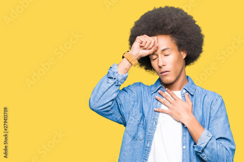 Young african american man with afro hair Touching forehead for illness and fever, flu and cold, virus sick