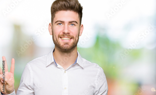 Young handsome business man showing and pointing up with fingers number three while smiling confident and happy. © Krakenimages.com