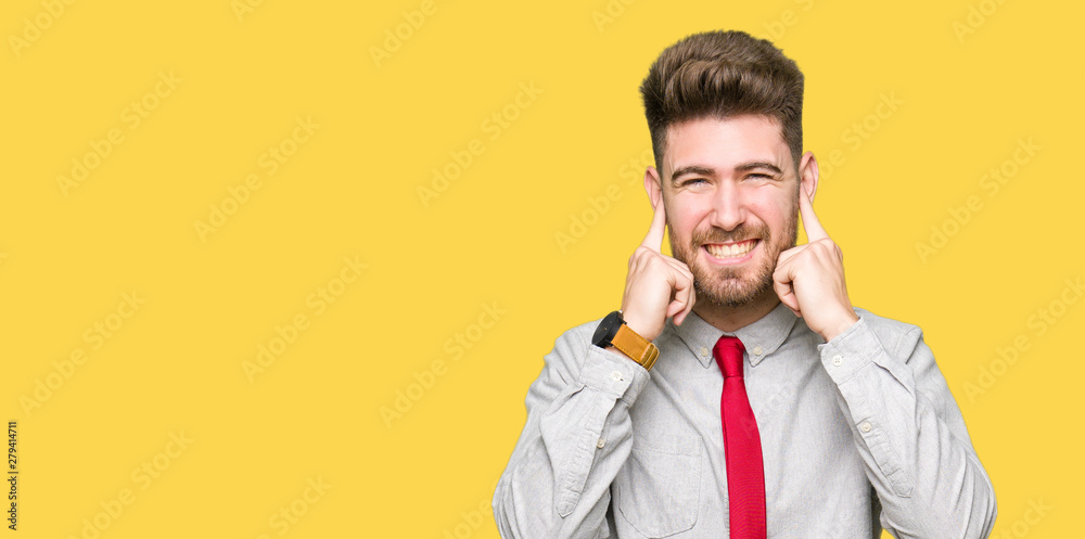 Young handsome business man covering ears with fingers with annoyed expression for the noise of loud music. Deaf concept. Young handsome business man covering ears with fingers with annoyed expression for the noise of loud music. Deaf concept.