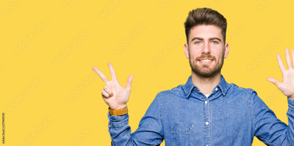 Young handsome blond man wearing casual denim shirt showing and pointing up with fingers number eight while smiling confident and happy. Young handsome blond man wearing casual denim shirt showing and pointing up with fingers number eight while smiling confident and happy.