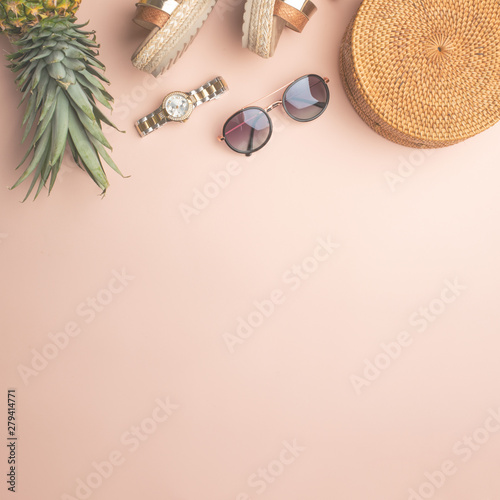 Summer background with wicker fashion bag, and women's summer shoes, pineapple and sun glasses, watches. Summer fashion, the concept of the holiday.