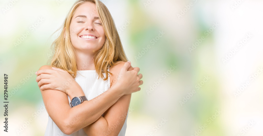 Beautiful young elegant woman over isolated background Hugging oneself happy and positive, smiling confident. Self love and self care - obrazy, fototapety, plakaty 