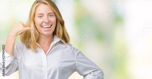 Beautiful young business woman over isolated background smiling doing phone gesture with hand and fingers like talking on the telephone. Communicating concepts.