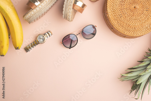 Summer background with a wicker fashion bag, and women's summer shoes, pineapple and sun glasses, watches. Summer fashion, the concept of a holiday. Fly lay.Banner
