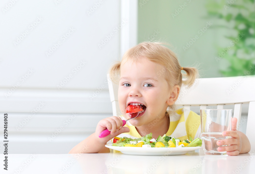 Little child eating healthy food vegetables salad,kid's nutrition. Little child eating healthy food vegetables salad,kid's nutrition.