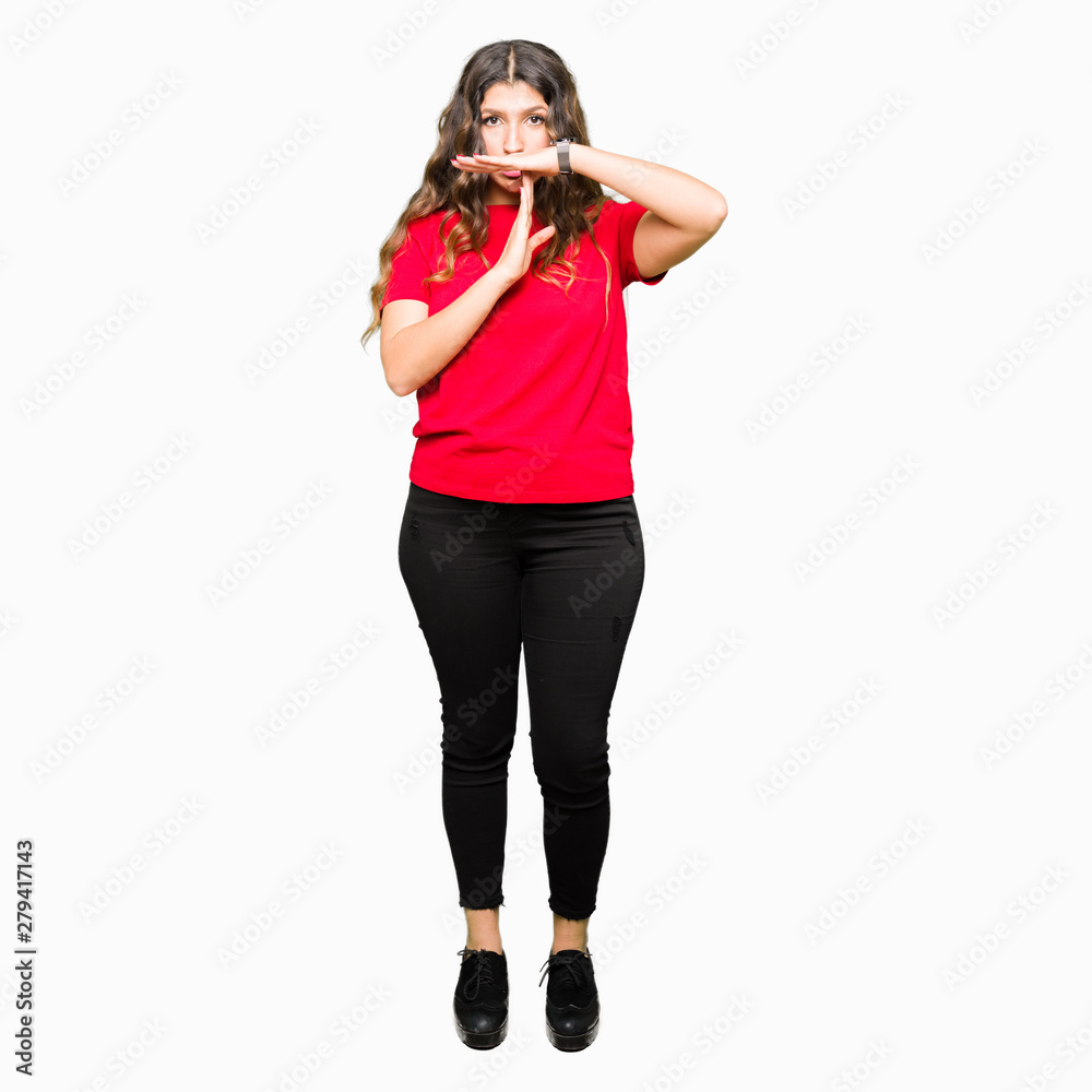 Young beautiful woman wearing casual t-shirt Doing time out gesture with hands, frustrated and serious face Young beautiful woman wearing casual t-shirt Doing time out gesture with hands, frustrated and serious face