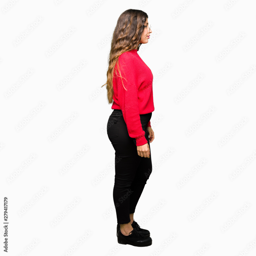 Young beautiful woman wearing red glasses looking to side, relax profile pose with natural face with confident smile. Young beautiful woman wearing red glasses looking to side, relax profile pose with natural face with confident smile.