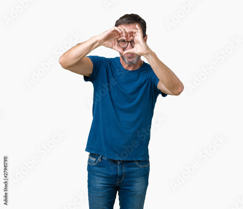 Handsome middle age hoary senior man wearin glasses over isolated background Doing heart shape with hand and fingers smiling looking through sign