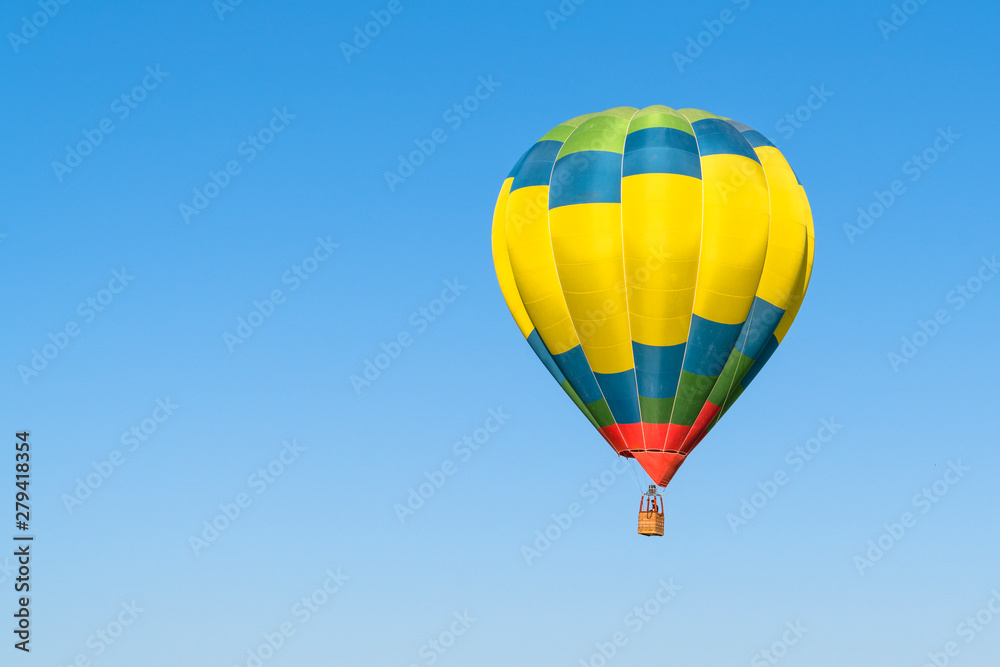 One colorful hot air balloon in blue sky One colorful hot air balloon in blue sky